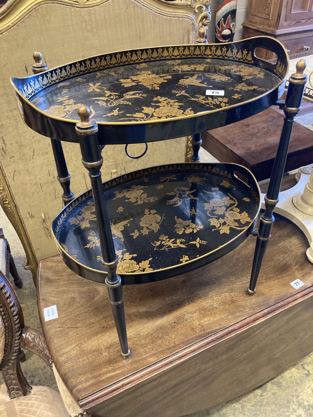 A black and gold japanned two tier toleware tray table, width 48cm, depth 36cm, height 57cm